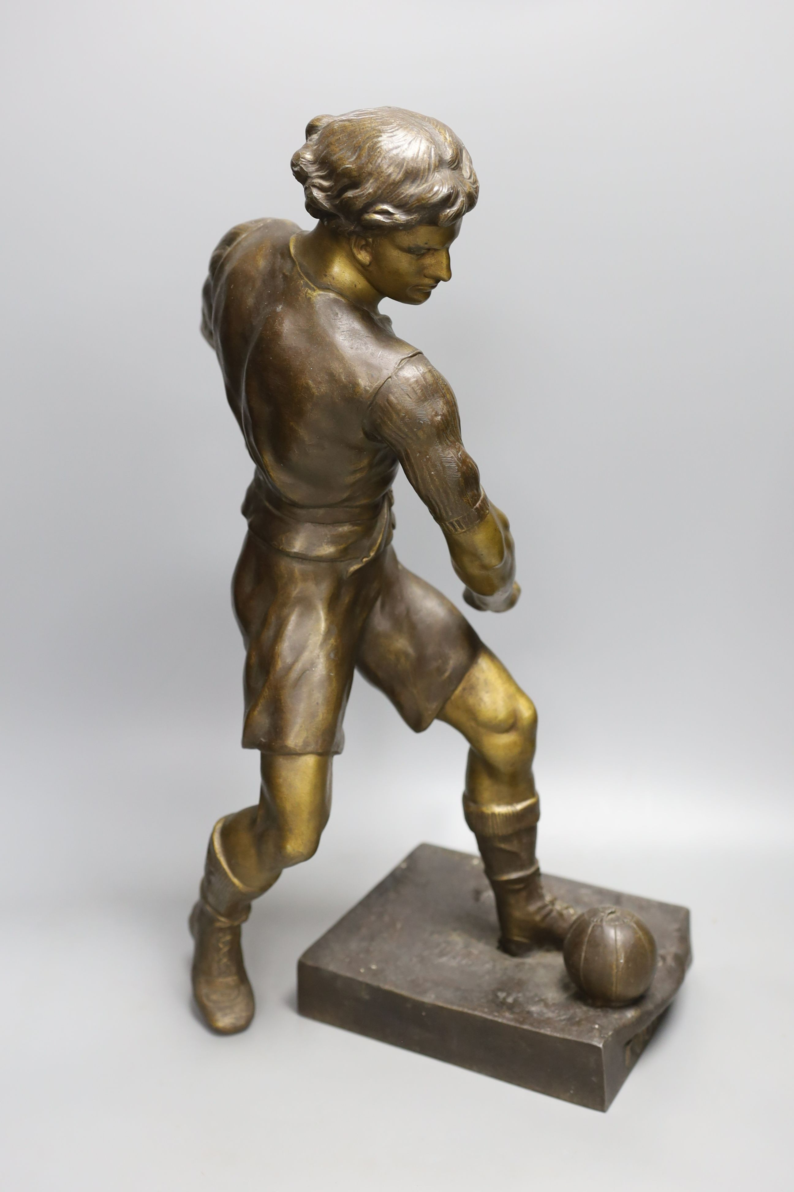 A bronzed spelter figure of a footballer after Picault - 50cm tall